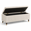 Banco de almacenamiento de tela beige con patas de madera